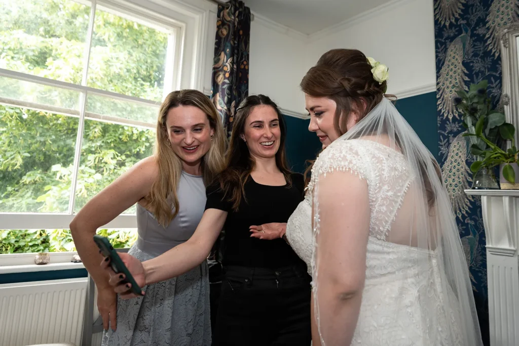 Ellen surrounded by her bridal party, sharing a joyful and intimate preparation moment