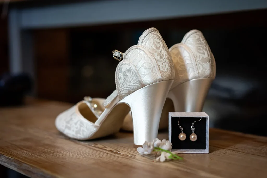 Elegant bridal shoes paired with classic pearl earrings, a harmony of wedding accessories