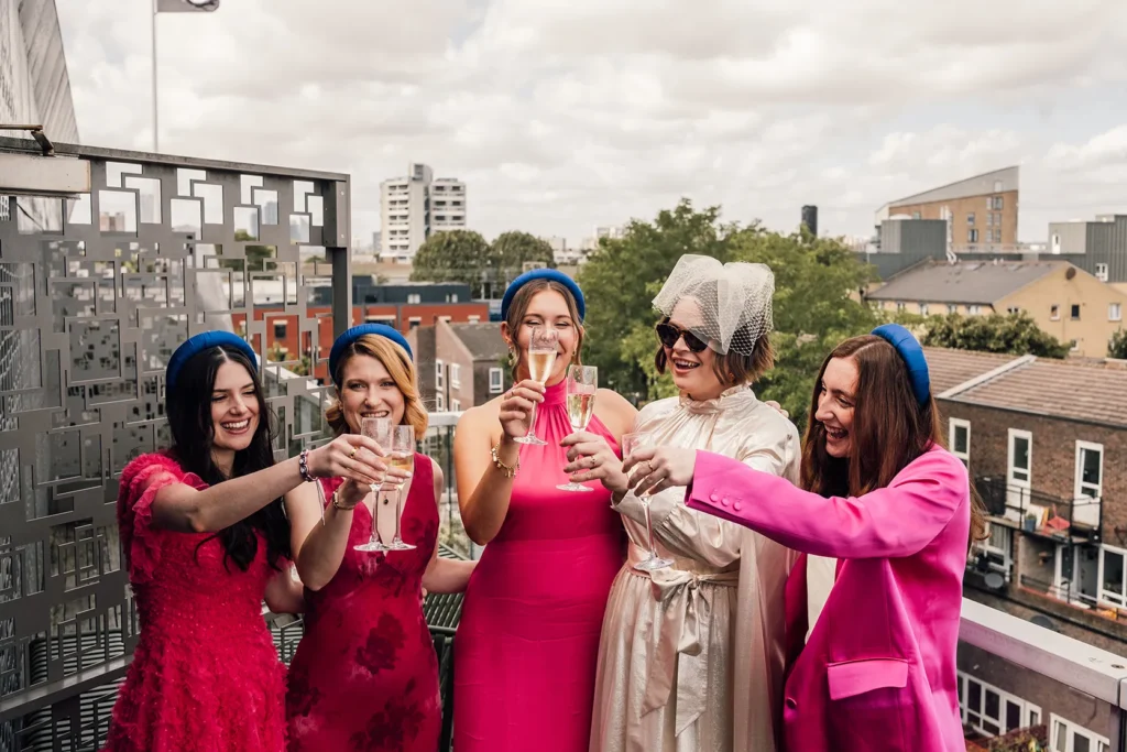 Bride Camilla toasting with bridesmaids at Town Hall Hotel London