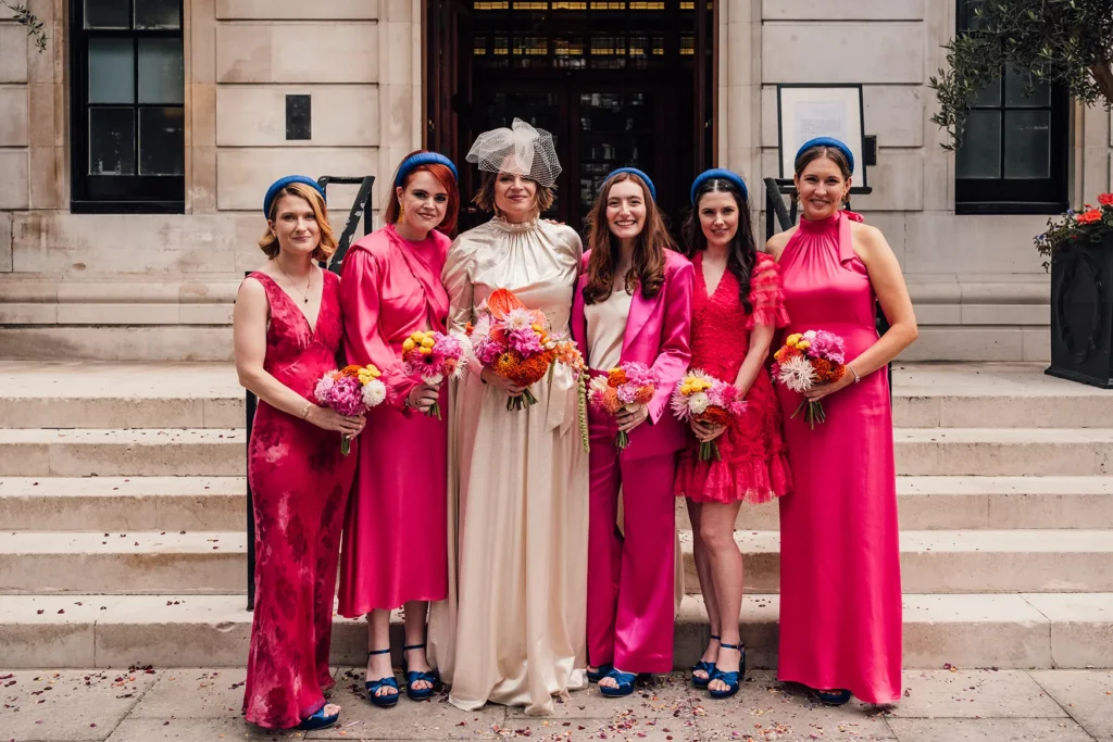 Bride Camilla with bridesmaids in pink dresses outside London Town Hall Hotel