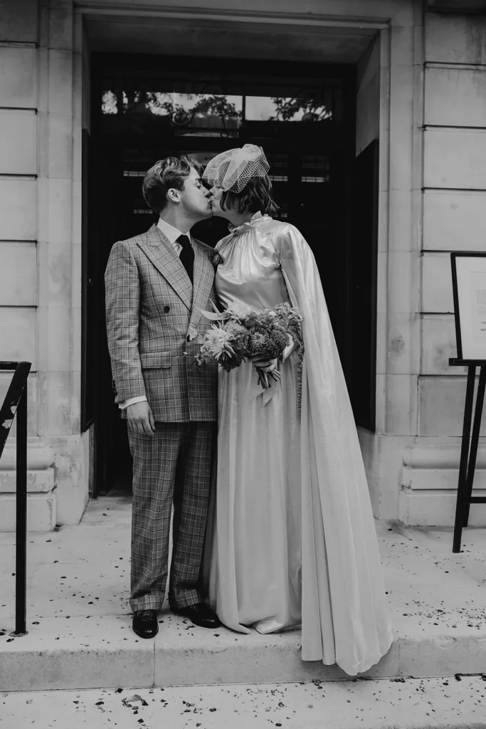 Bride Camilla and groom Nathan sharing a kiss in London