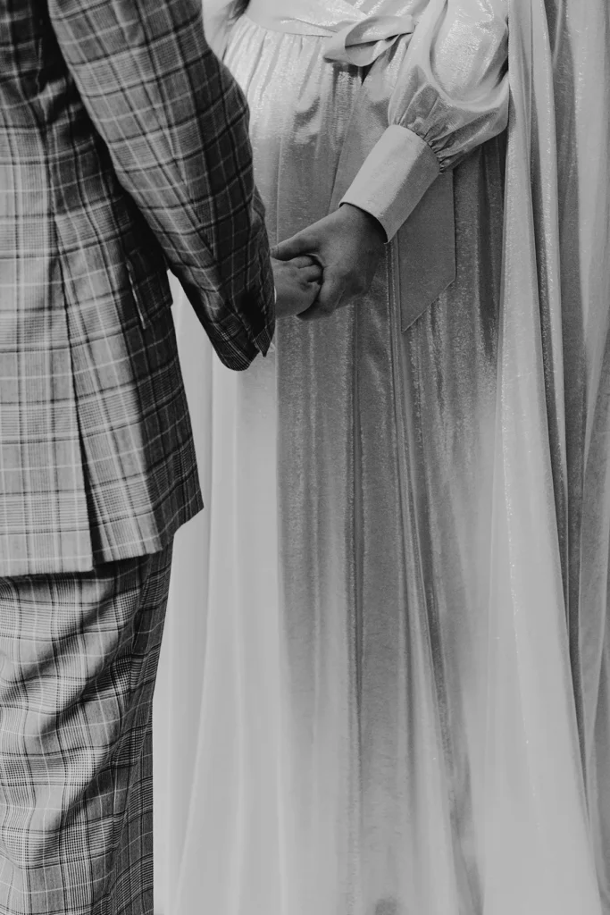 Close-up of bride Camilla holding hands with groom in London