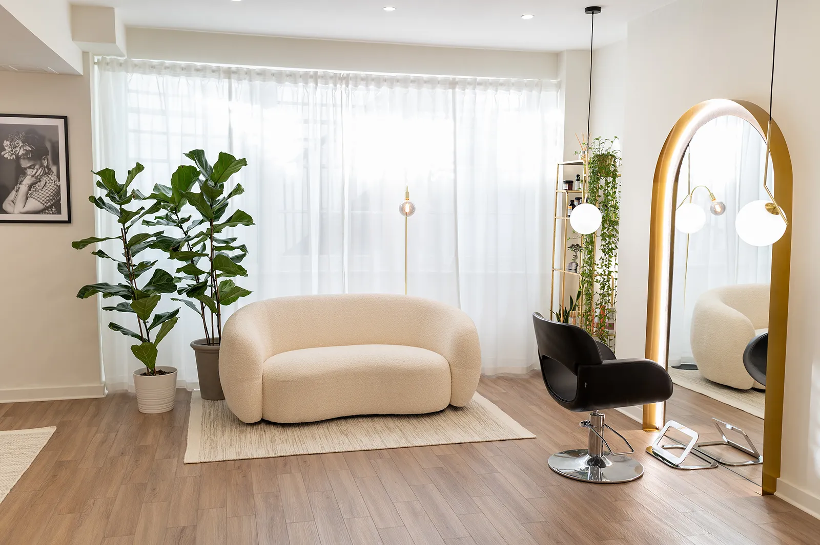 A chic and inviting hair salon lounge area with contemporary furniture and lush green plants, showcasing the comfortable and stylish environment at the best hair salon in Islington.