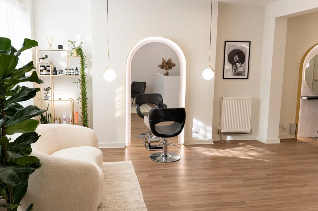 A view of an elegant hair spa and boutique in Islington, featuring sleek hairdressing chairs and a calming white and gold décor, reflecting the luxury experience offered by the top hair salon in the area.