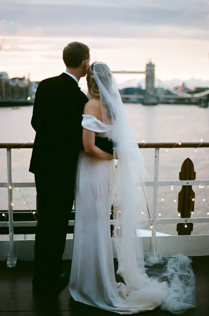 Bride and groom enjoying a moment on a boat in London