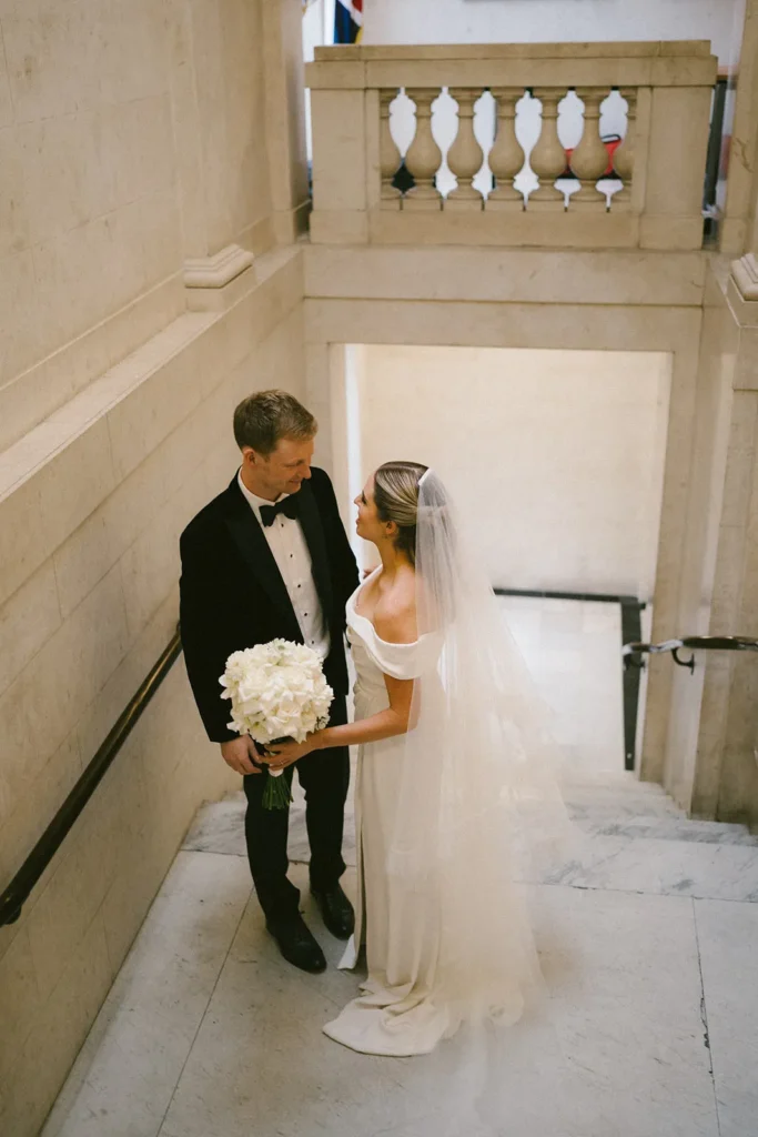 Intimate moment between bride and groom at Marylebone Town Hall staircase in London