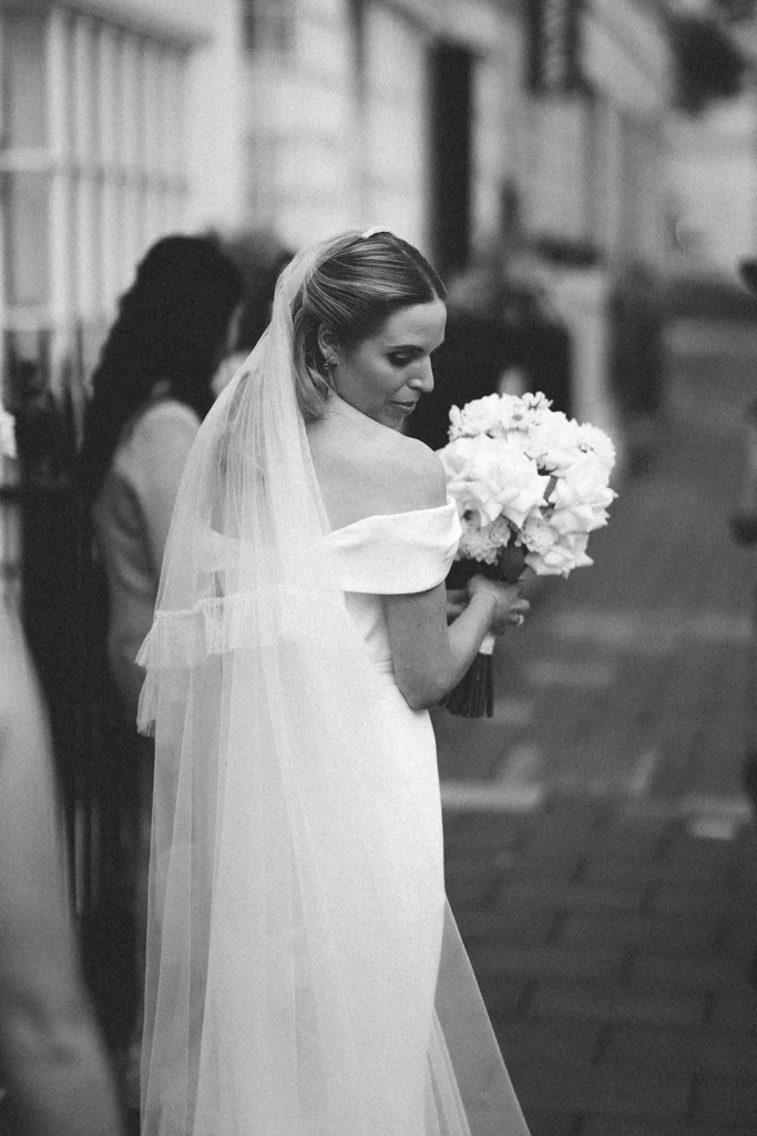Bride holding a bouquet in a timeless black and white portrait in London