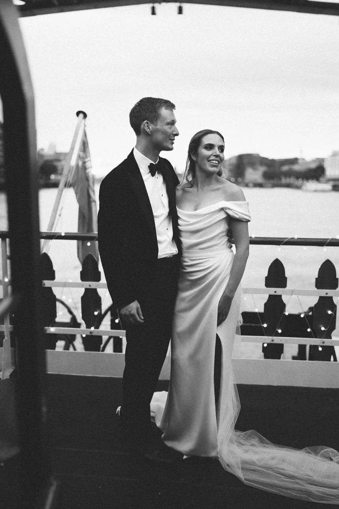 Bride and groom in a candid black and white moment on a London boat