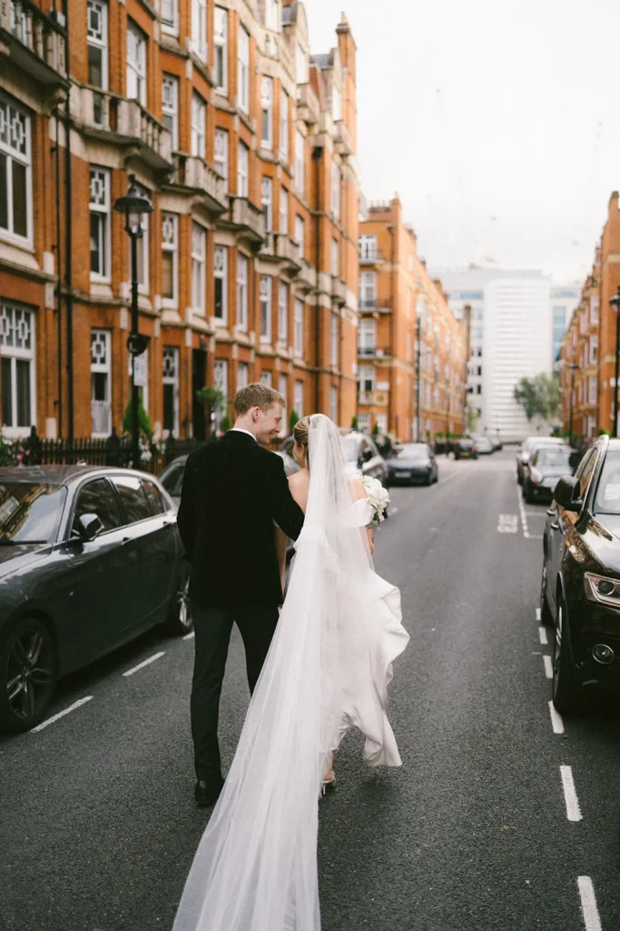 Bride and groom walking through a London street post-ceremony