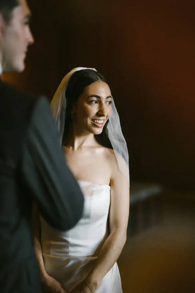 Bride smiling brightly at the altar in a minimalist London wedding