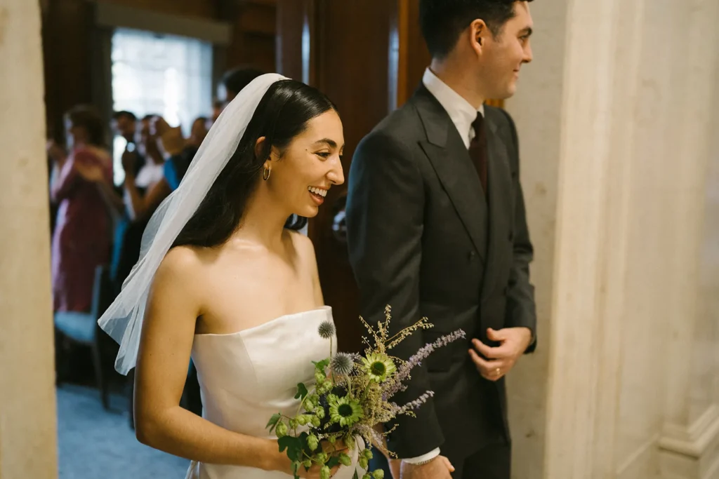 Bride and groom sharing a joyful moment during their London wedding at the Old Marylebone Town Hall.
