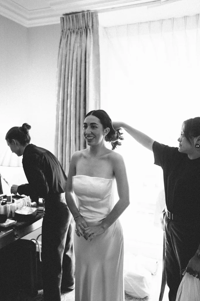 Bride being prepared for her wedding, smiling in anticipation in London at the Landmark Hotel