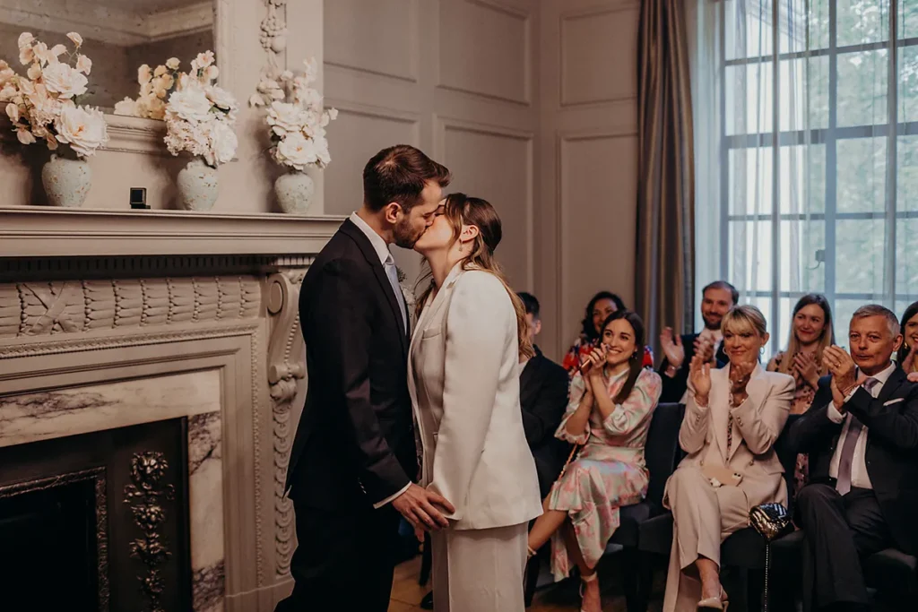 Couple sharing a kiss during intimate micro wedding ceremony in London