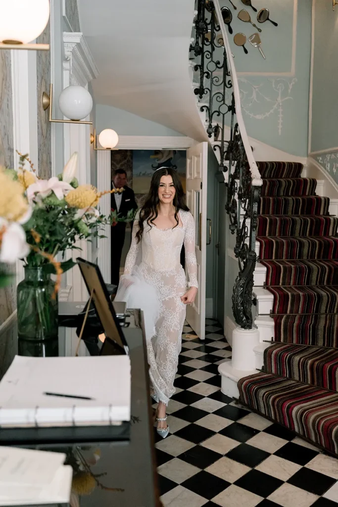 Bride walking down a staircase in a lace gown at a micro wedding in London