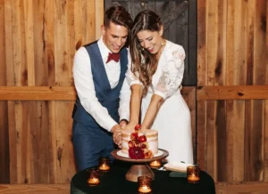 Bride and groom cutting a minimalist wedding cake in a rustic venue