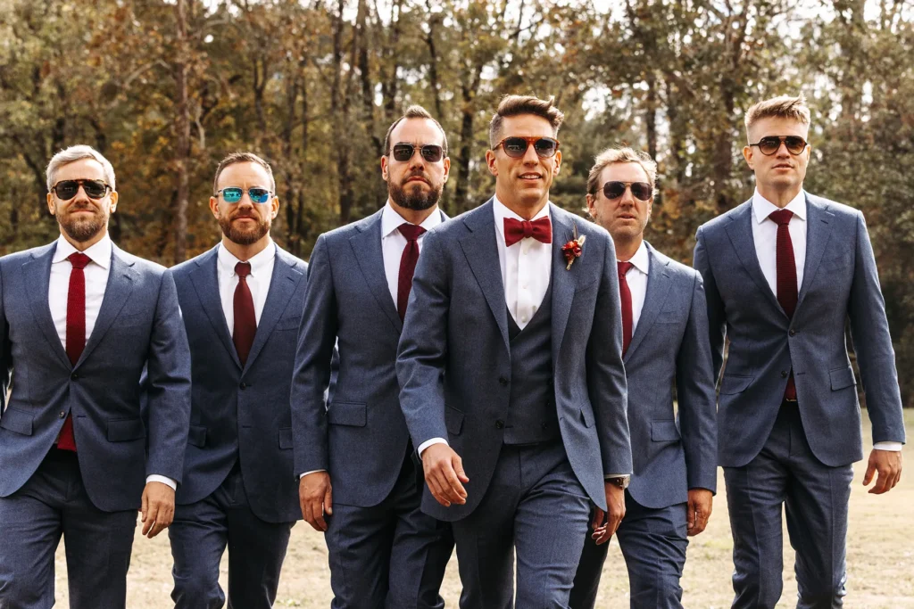 Groom and groomsmen walking in style with matching suits and sunglasses