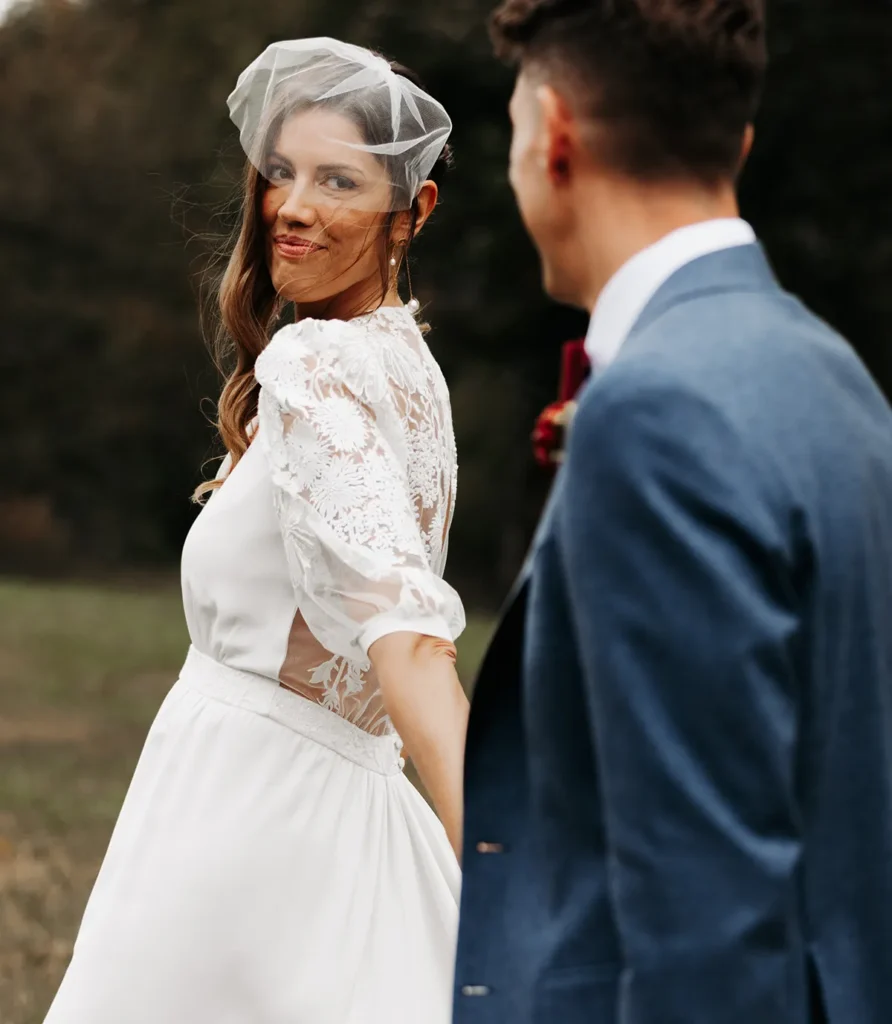 Bride smiling at groom during boho chic wedding ceremony