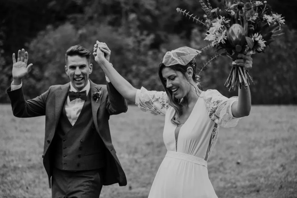 Bride and groom holding hands and celebrating after wedding ceremony