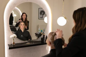 Bride getting her hair styled in a salon, with reflection in the mirror