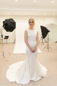 Bride posing in an elegant white gown in a professional photoshoot setting