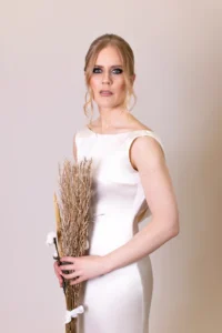 Bride in white gown holding a bouquet of dried flowers for a bridal photoshoot