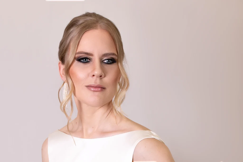 Close-up of bride with smokey eye makeup and elegant curled updo