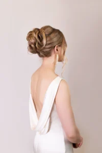 Elegant updo bridal hairstyle with blonde curls in a side profile