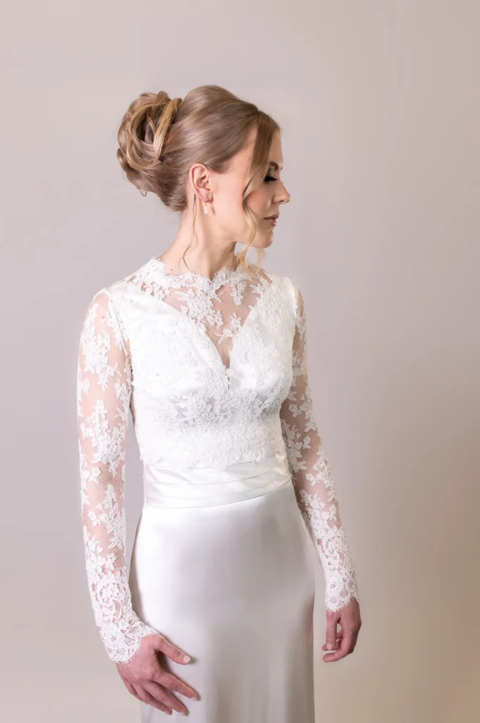 Bride in lace long-sleeved gown with intricate lace detailing