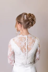 Back view of lace bridal gown with buttoned details and updo hairstyle