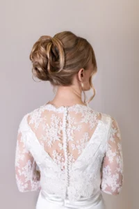 Bridal updo hairstyle detail on a bride in lace gown during photoshoot