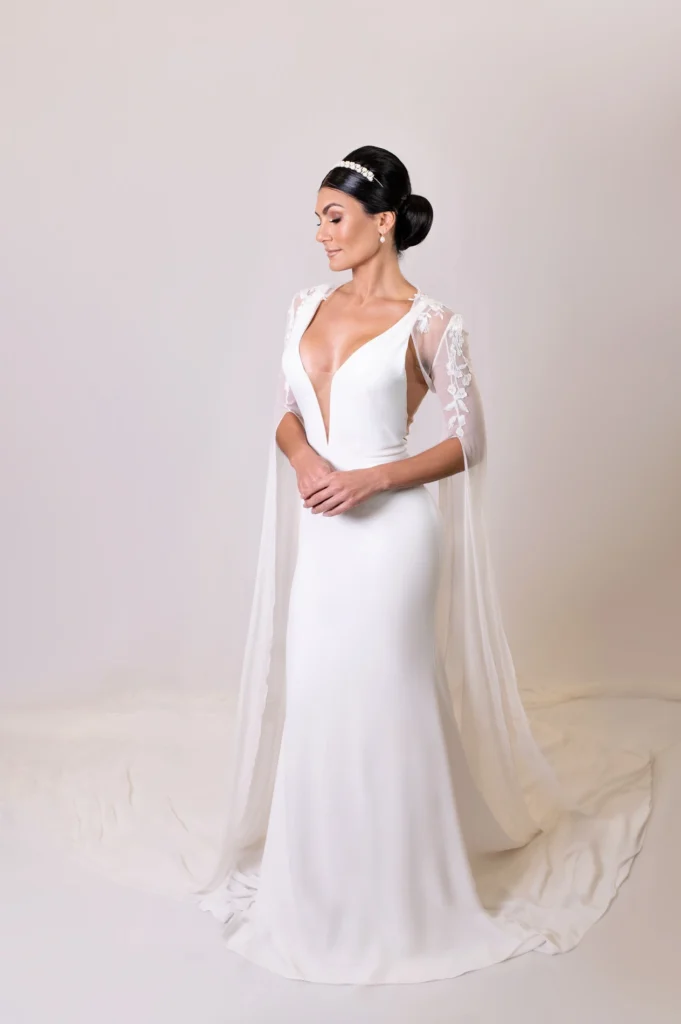 Bride wearing a minimalist wedding gown with deep V-neck and sleek updo