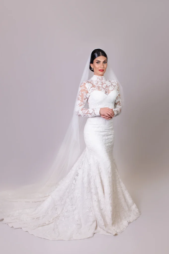 Bride in lace mermaid wedding gown with long veil