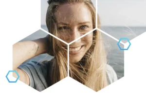 Woman smiling outdoors with windblown hair, showcasing the benefits of safe hair colour practices after allergy testing.