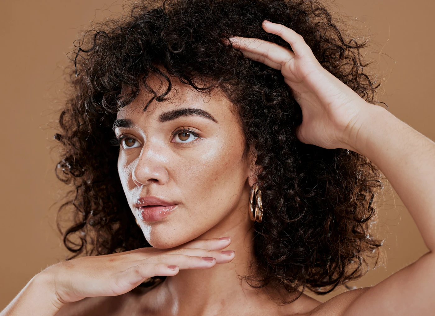 Close-up of a woman with natural afro hair scalp care.