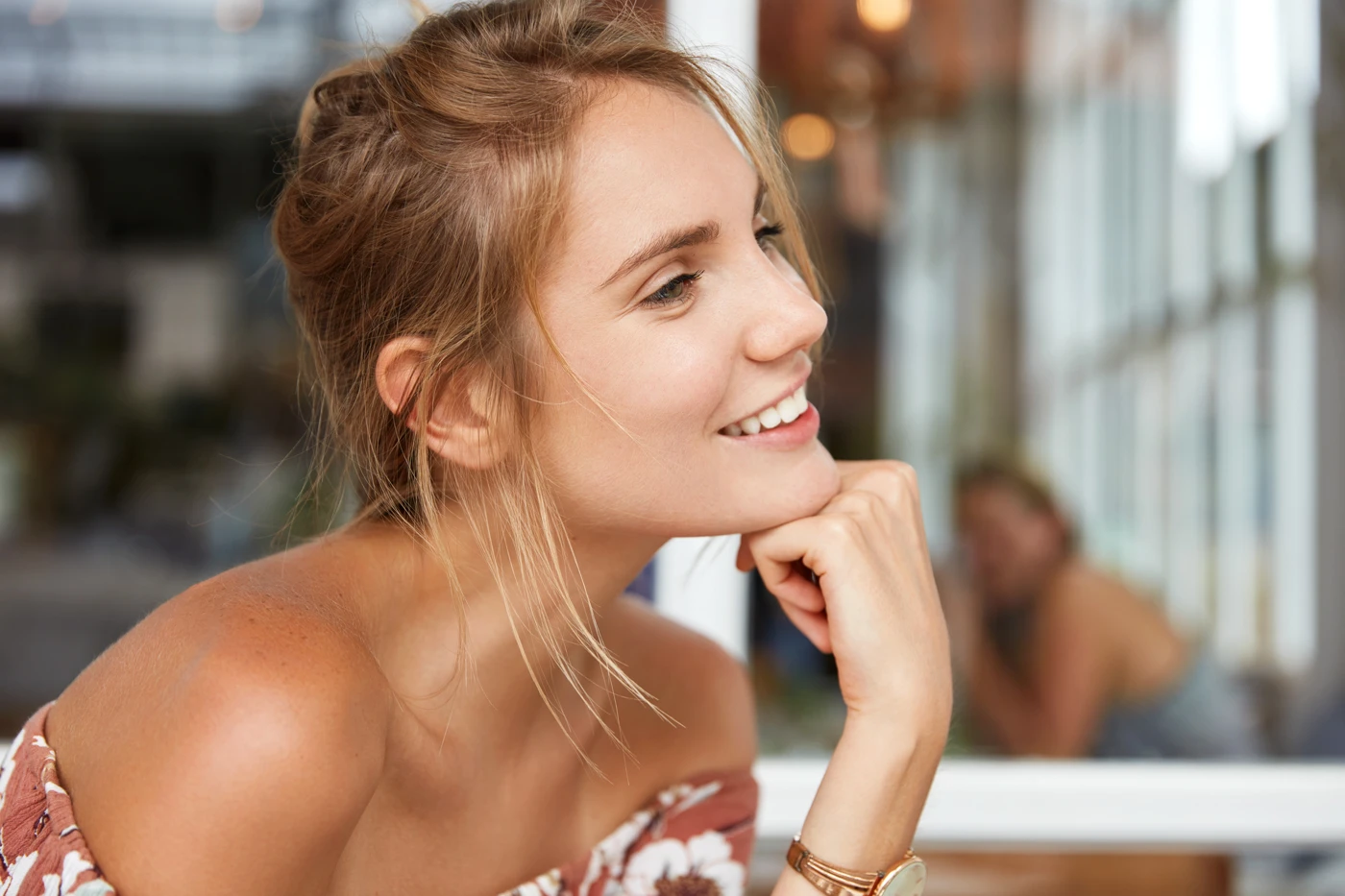 Smiling woman with a casual hairstyle enjoying a relaxed moment.