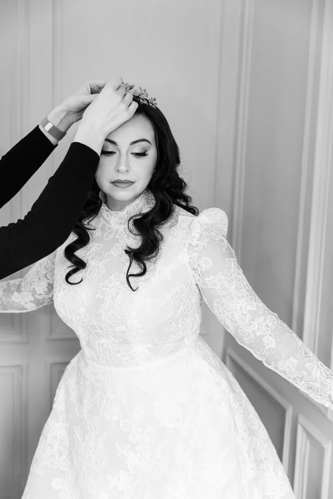 Bride’s tiara being placed with care, enhancing her winter wonderland look.