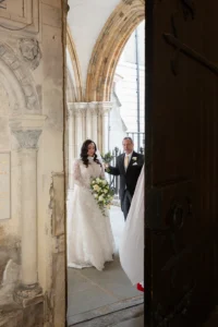 Bride and father arriving at a historic church for a winter wedding.