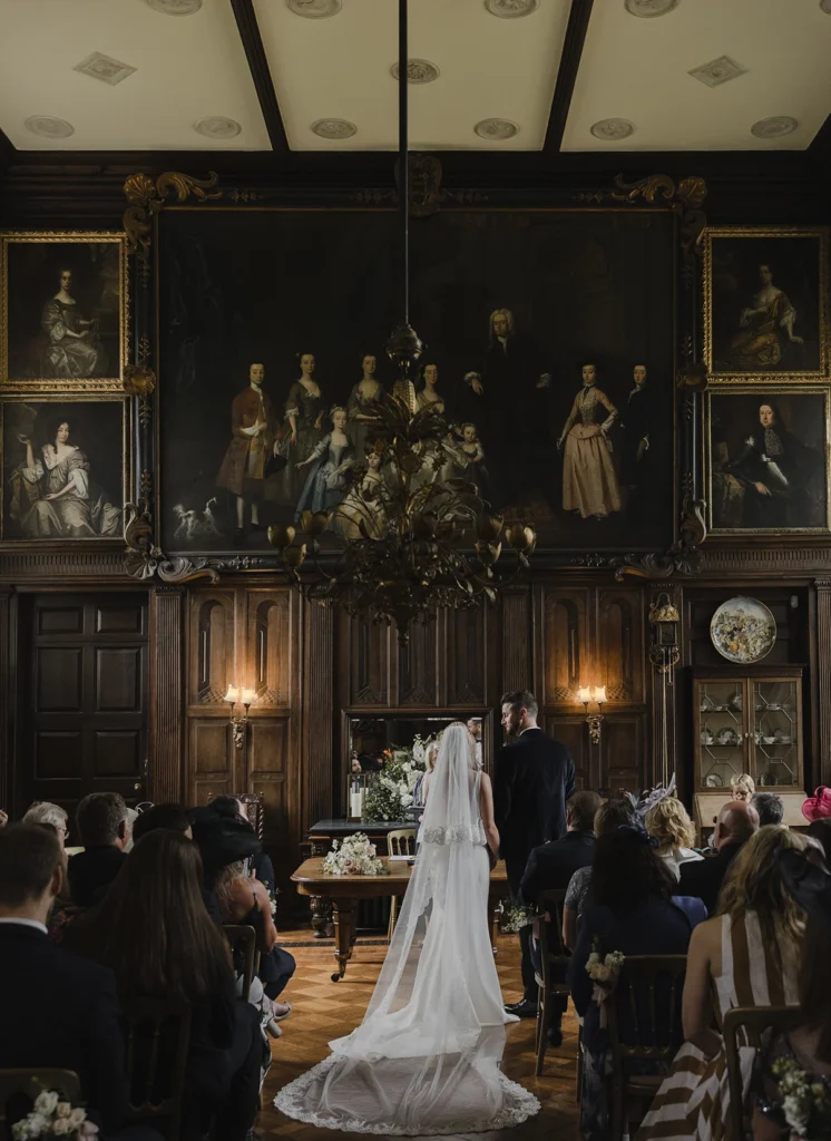 Wide shot of Loseley Park wedding ceremony inside historic hall