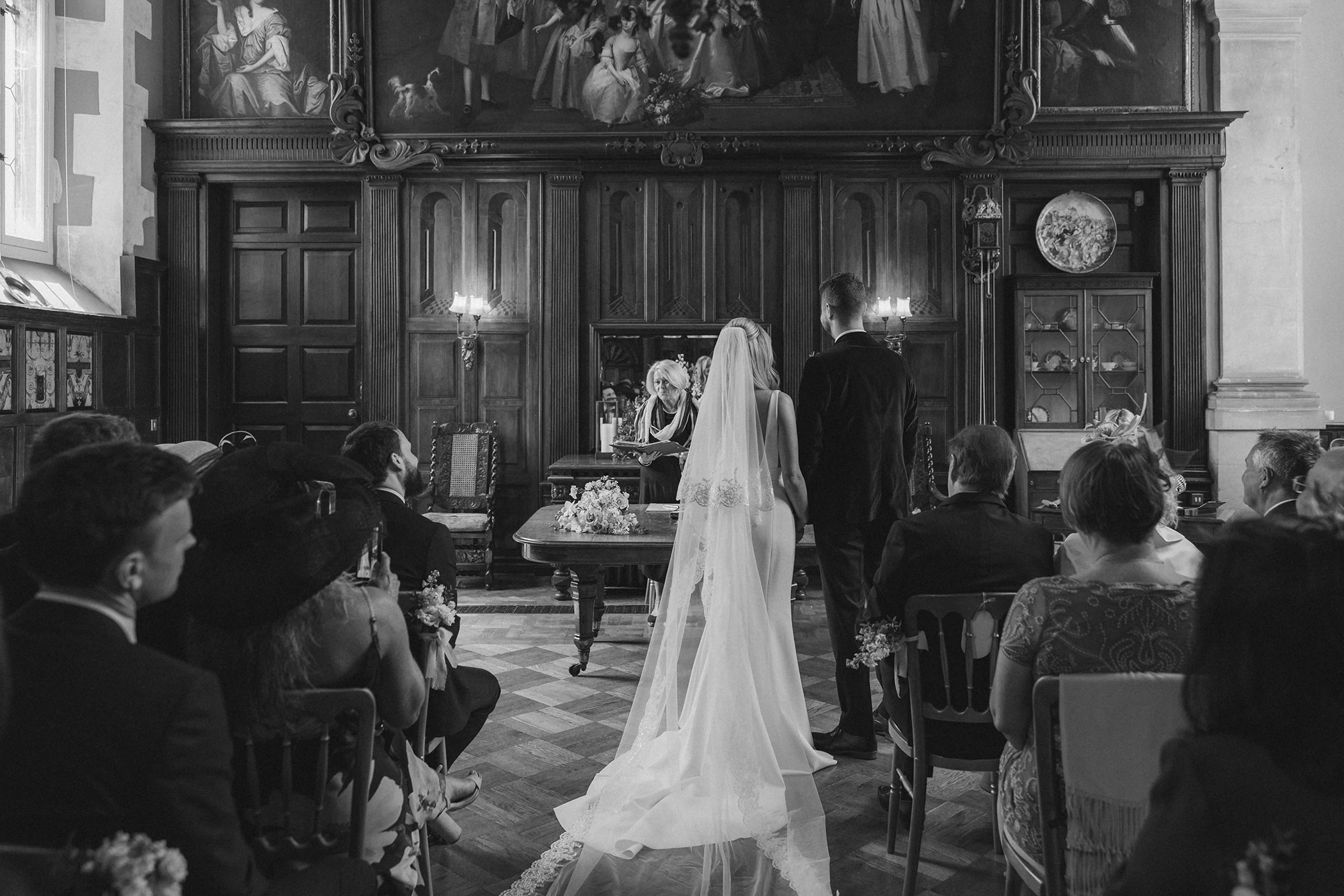 Black and white photo of bride and groom during Loseley Park wedding ceremony