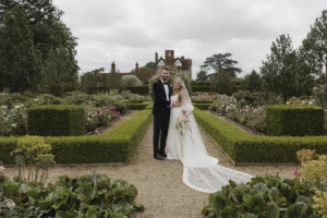 Bride and groom in the beautifully landscaped gardens of Loseley Park.