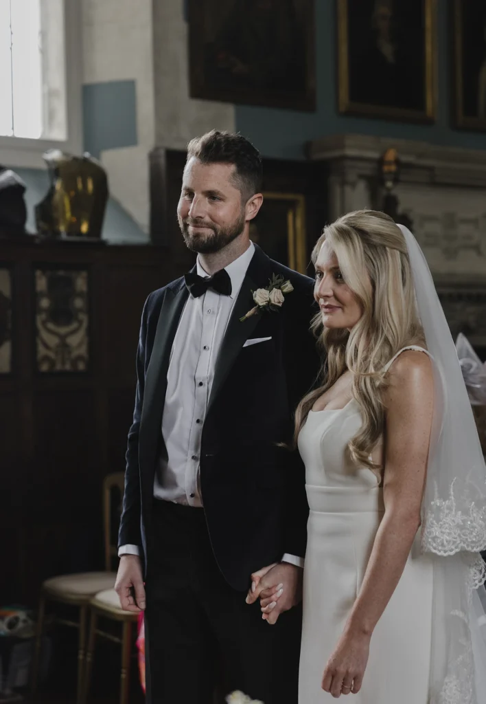 Bride and groom standing together at the altar at Loseley Park wedding