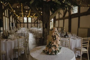 Beautiful wedding cake decorated with flowers at Loseley Park reception