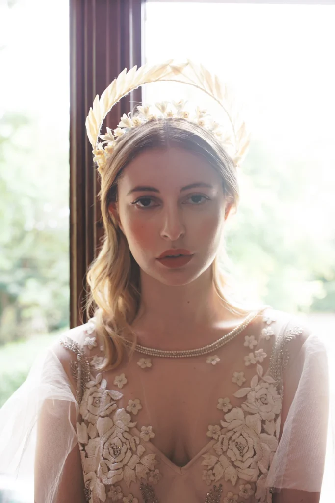 Bride wearing an elegant gold headpiece at Nutfield Priory, captured with soft natural lighting