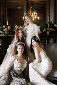 Brides posing in a luxurious interior surrounded by floral arrangements at Nutfield Priory.