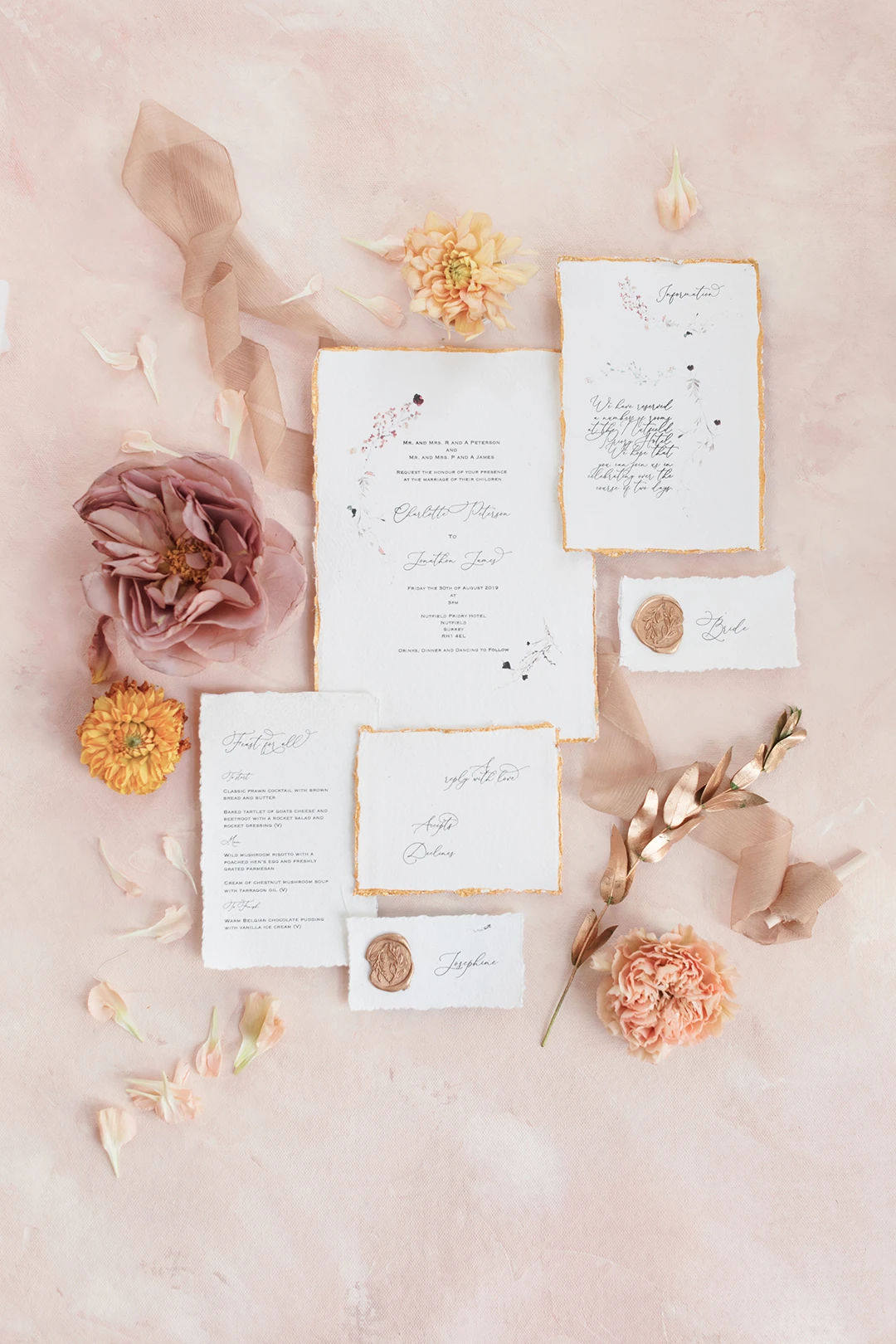 Artistic shot of wedding stationery featuring elegant calligraphy and floral details at Nutfield Priory.