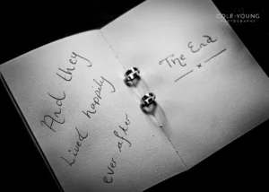 Wedding rings displayed on an open book with happily ever after text at Pelham House.