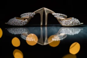 Luxurious bridal shoes embellished with pearls, reflecting elegantly during Pelham House wedding shoot.