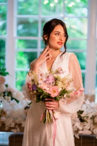 Close-up of the bride’s bouquet and pearl-embellished dress during Pelham House wedding photoshoot.