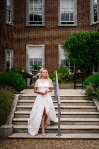 A bride gracefully walking down the steps of Pelham House during the photoshoot.