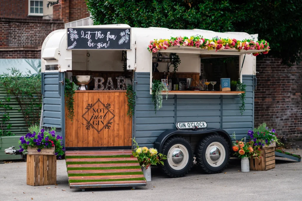 Rustic bar setup with floral decorations at the Pelham House photoshoot.